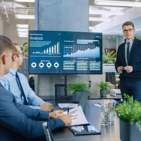 Business team meeting viewing analytics presentation screen